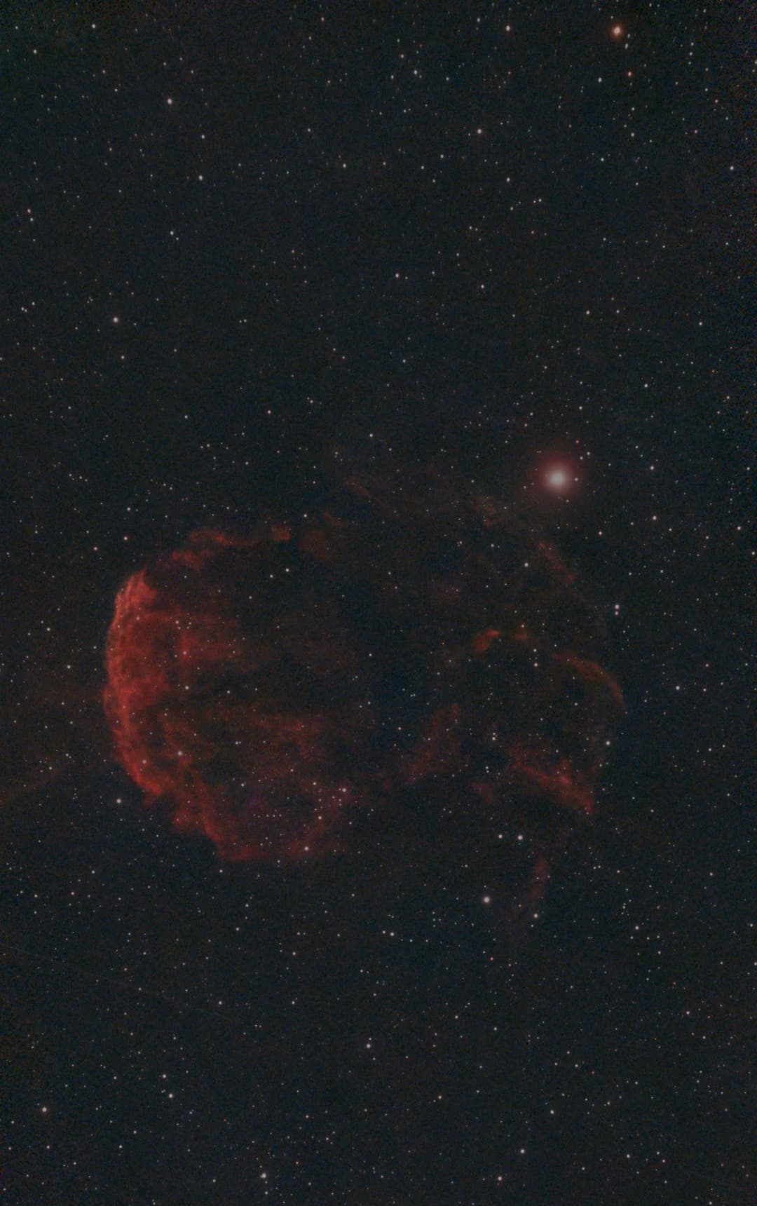 Dash's photograph of the arcing red shell of the Jellyfish Nebula