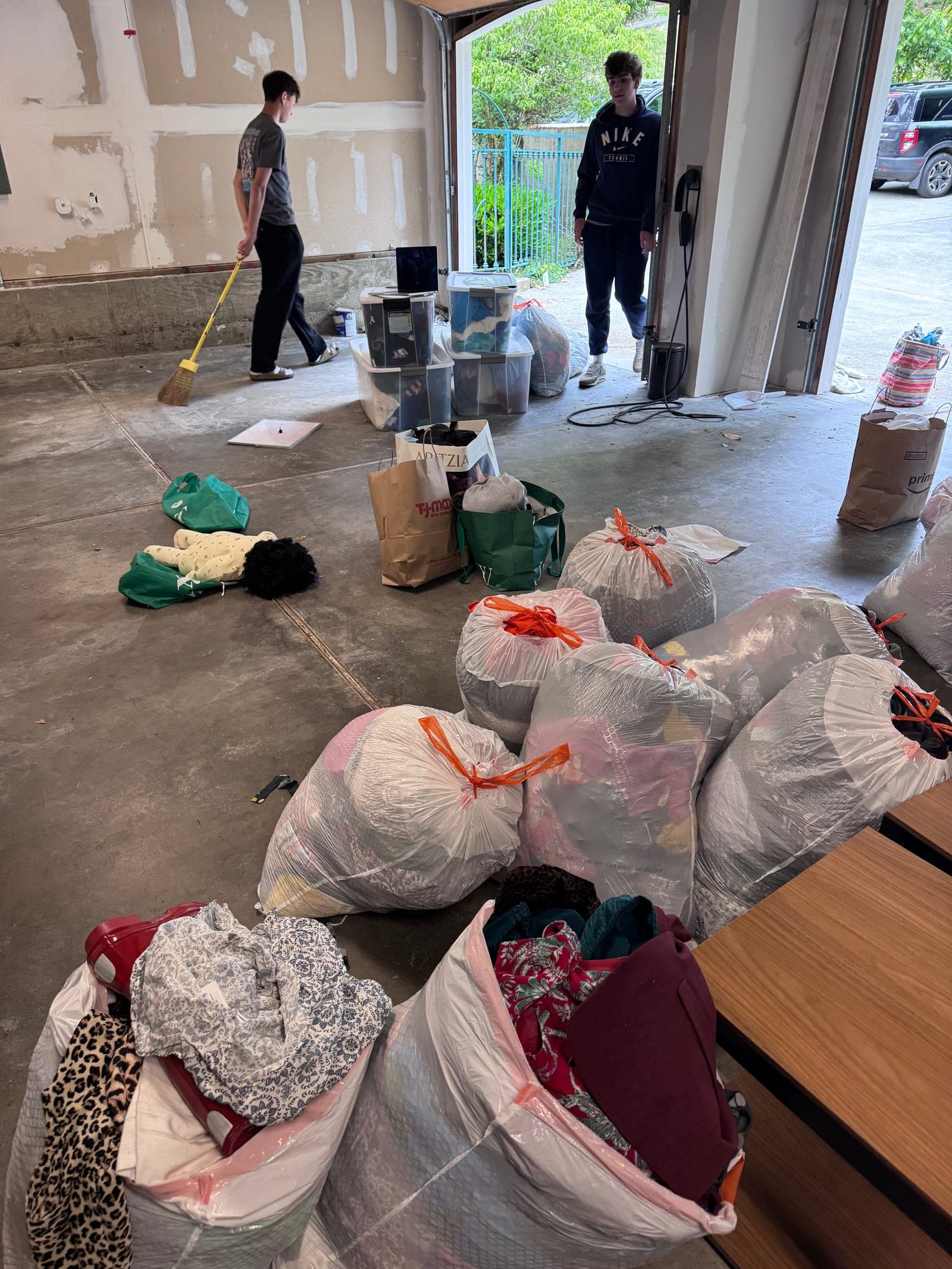 Project Ascend volunteers sorting bags of donated clothing